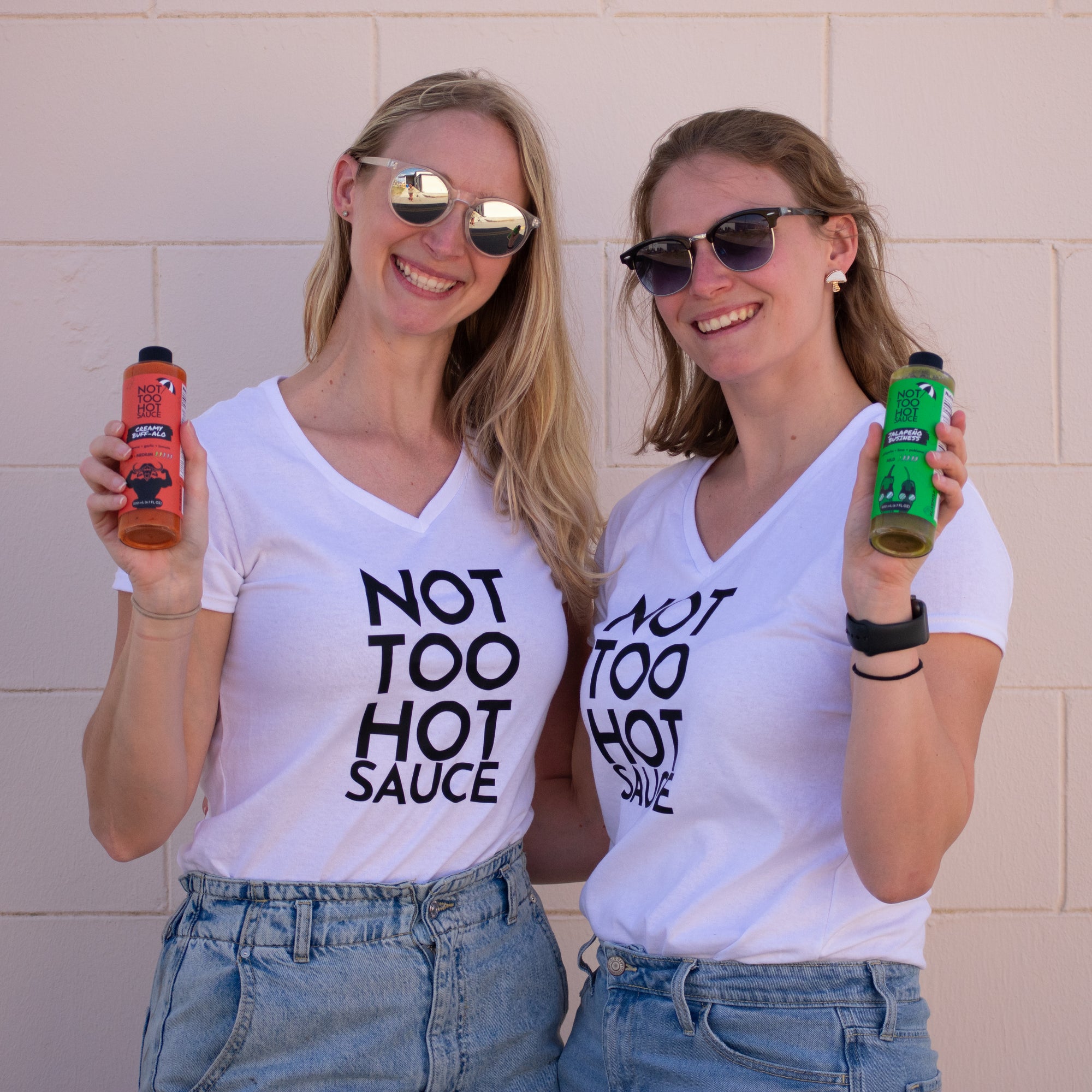 Melody and Angela holding hot sauces